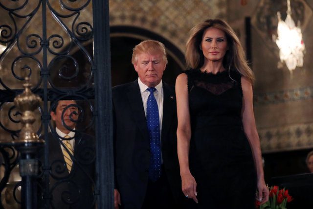 U.S. President Donald Trump, First Lady Melania Trump and Japanese Prime Minister Shinzo Abe (L) walk to pose for a photograph before attending dinner at Mar-a-Lago Club in Palm Beach, Florida, U.S., February 11, 2017. REUTERS/Carlos Barria