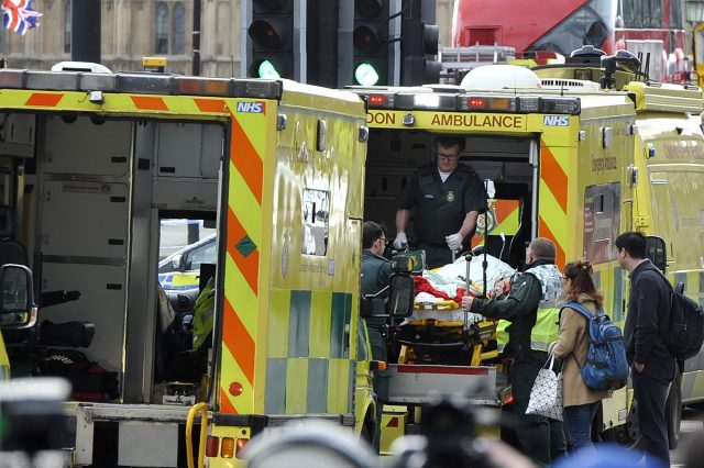 Paramedics load a victim into the back of an ambulance as members of the emergency services work on Westminster Bridge, alonside the Houses of Parliament in central London on March 22, 2017, during an emergency incident. British police shot a suspected attacker outside the Houses of Parliament in London on Wednesday after an officer was stabbed in what police said was a "terrorist" incident. / AFP PHOTO / NIKLAS HALLE'N