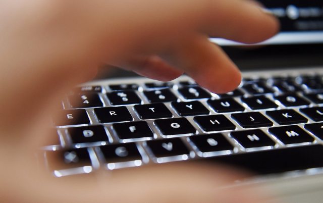 epa04605760 A hand operates above a laptop's keyboard in London, Britain, 06 February 2015. The Investigatory Power Tribunal on 06 February 2015 ruled, that Britain's intelligence agency GCHQ sharing private communications of UK residents with US authorities was contravening Articles from the European Court of Human Rights (ECHR) but now complies.  EPA/ANDY RAIN