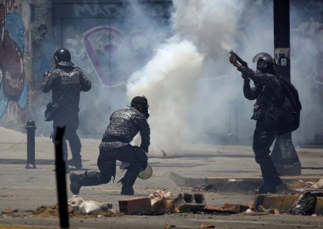 Security forces members fire tear gas canisters after clashes broke out while the Constituent Assembly election was being carried out in Caracas, Venezuela, July 30, 2017. REUTERS/Carlos Garcia Rawlins