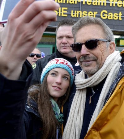 epa03574691 US actor Kevin Kostner (R) poses with an unidentified fan for a souvenir photo as he arrives as a spectator to watch the Men's downhill race as part of the Alpine Skiing World Championships in Schladming, Austria, 09 February 2013.  EPA/ROBERT PARIGGER