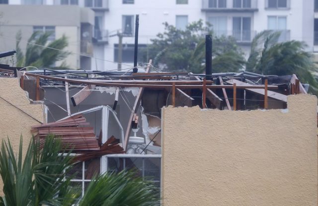 epa06197214 A home with severe roof damage after the full effects of Hurricane Irma struck in Miami, Florida, USA, 10 September 2017. Many areas are under mandatory evacuation orders as Irma Florida. EPA/ERIK S. LESSER