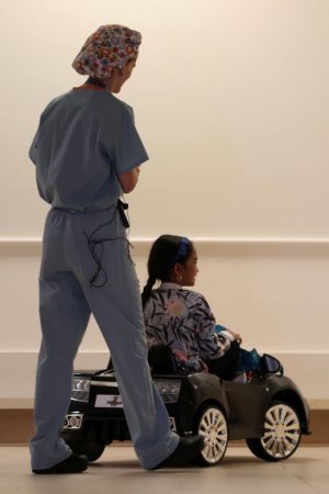Doctor Daniela Carvalho controls Andrea Destraio, 5, remotely as Rady Children's Hospital unveil a program that uses remote control cars, donated by the local police officers charity to take young patients to the operating room, in San Diego, California, U.S. September 19, 2017.     REUTERS/Mike Blake