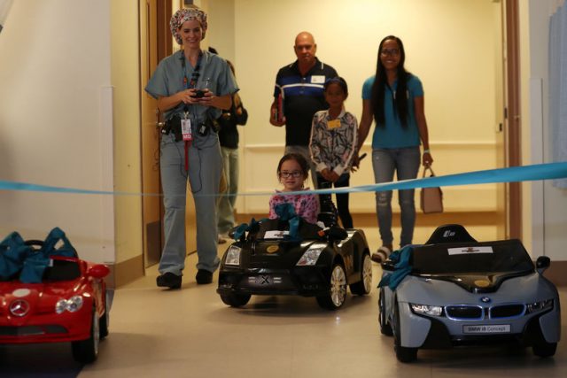 Doctor Daniela Carvalho controls Andrea Destraio, 5, remotely as Rady Children's Hospital introduces a new program that uses remote control cars, donated by the local police officers charity, to take young patients to the operating room, in San Diego, California, U.S. September 19, 2017.     REUTERS/Mike Blake
