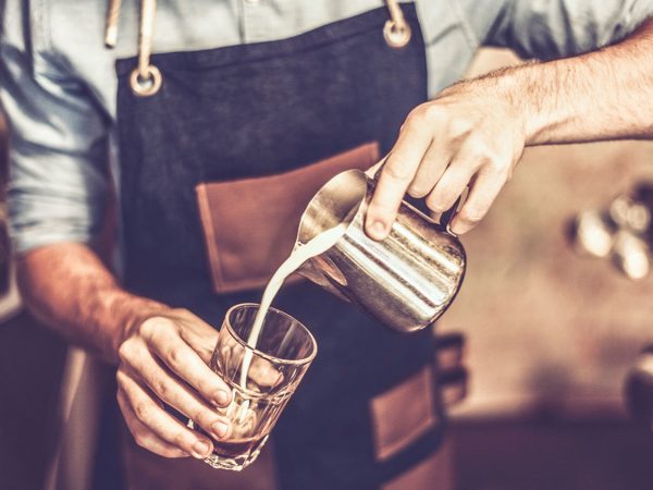 Young barista is making a coffee