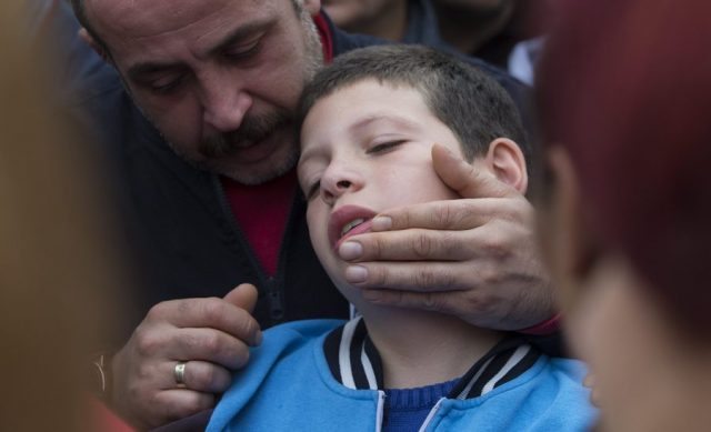 epa04973593 People try to comfort nine years old Cayan, son of slain Sarigul Tuylu who was killed in a blast in Ankara during a funeral in Istanbul, Turkey, 11 October 2015, one day after multiple explosions where set off at a rally, in Ankara. Twin bomb blasts on 10 October killed 95 people gathering for a pro-Kurdish peace rally in the Turkish capital, Ankara, in the worst attack in Turkey's modern history. No group has claimed responsibility for the attack, which comes just three weeks before snap general elections set for 01 November and the G20 heads-of-government summit later next month, raising security concerns.  EPA/TOLGA BOZOGLU