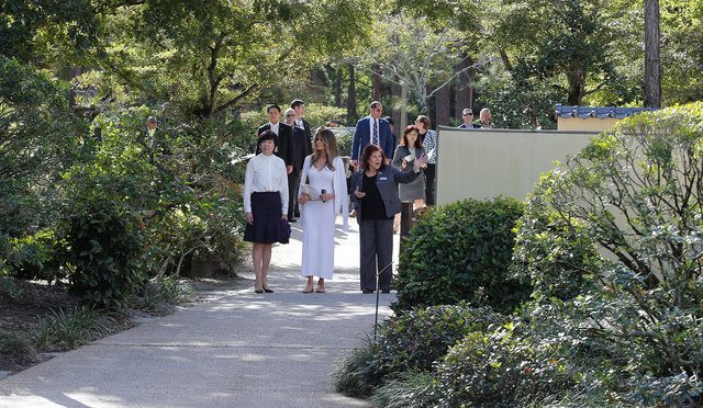 U.S. First Lady Melania Trump (C) and Akie Abe (L), wife of Japanese Prime Minister Shinzo Abe, listen to Park Administrator Bonnie White Lemay, as they tour Morikami Museum and Japanese Gardens in Delray Beach, Florida, U.S., February 11, 2017.  REUTERS/Joe Skipper