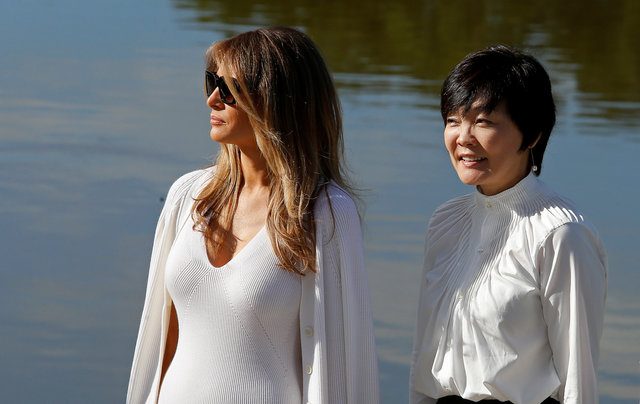 U.S. First Lady Melania Trump (L) and Akie Abe, wife of Japanese Prime Minister Shinzo Abe, listen to a guide as they tour Morikami Museum and Japanese Gardens in Delray Beach, Florida, U.S., February 11, 2017.  REUTERS/Joe Skipper