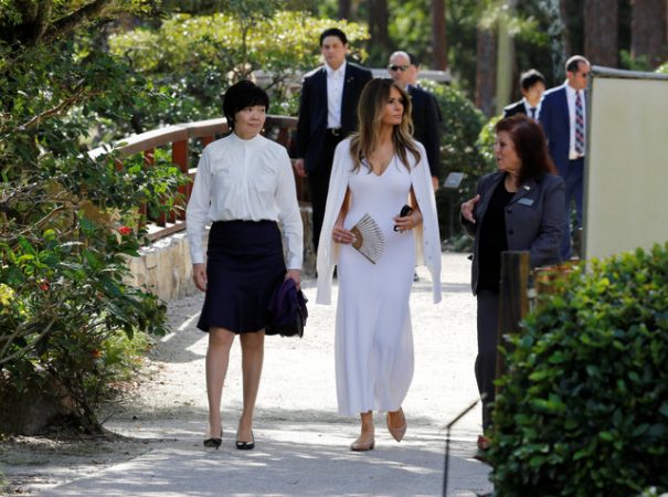 U.S. First Lady Melania Trump (C) and Akie Abe (L), wife of Japanese Prime Minister Shinzo Abe, listen to Park Administrator Bonnie White Lemay, as they tour Morikami Museum and Japanese Gardens in Delray Beach, Florida, U.S., February 11, 2017.  REUTERS/Joe Skipper