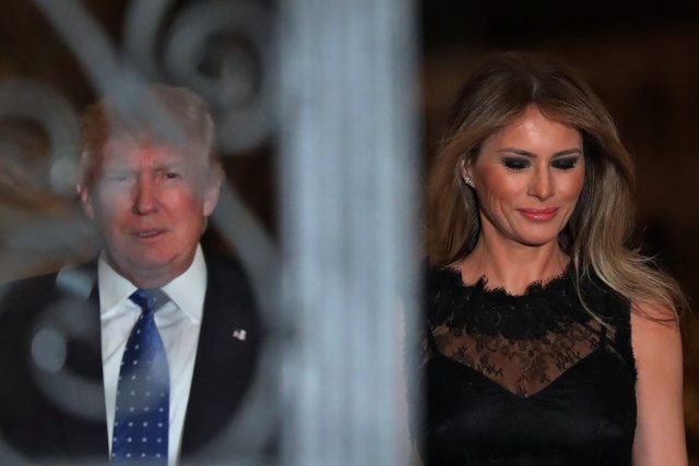 U.S. President Donald Trump and First Lady Melania Trump walk to pose for a photograph before attending dinner at Mar-a-Lago Club in Palm Beach, Florida, U.S., February 11, 2017. REUTERS/Carlos Barria