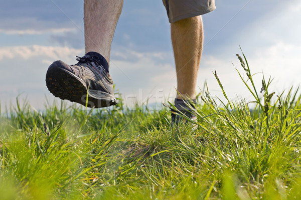 947256_stock-photo-man-walking-on-grass-exercise-outdoors