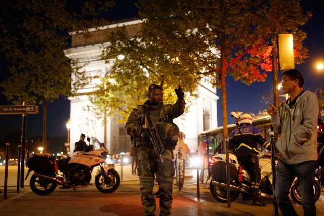 An armed soldier secures a side road near the Champs Elysees Avenue after two policemen were killed and another wounded in a shooting incident in Paris, France, April 20, 2017. REUTERS/Benoit Tessier