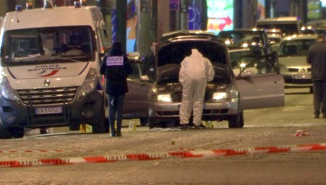 A still image from video footage shows Police investigators inspect the car used by the attacker on the Champs Elysees Avenue after two policemen were killed and another wounded in a shooting incident in Paris, France, April 20, 2017. REUTERS/Reuters Tv