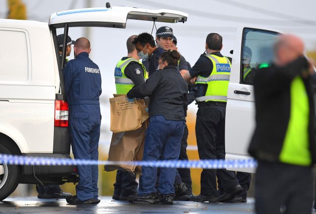 Australian forensic police hold an evidence bag which reads 'hard covered book with Arabic writing' at the site of a siege at the Buckingham Serviced Apartments in Melbourne, Australia, June 6, 2017. AAP/Julian Smith/via REUTERS ATTENTION EDITORS - THIS PICTURE WAS PROVIDED BY A THIRD PARTY. EDITORIAL USE ONLY. NO RESALES. NO ARCHIVE. AUSTRALIA OUT. NEW ZEALAND OUT.