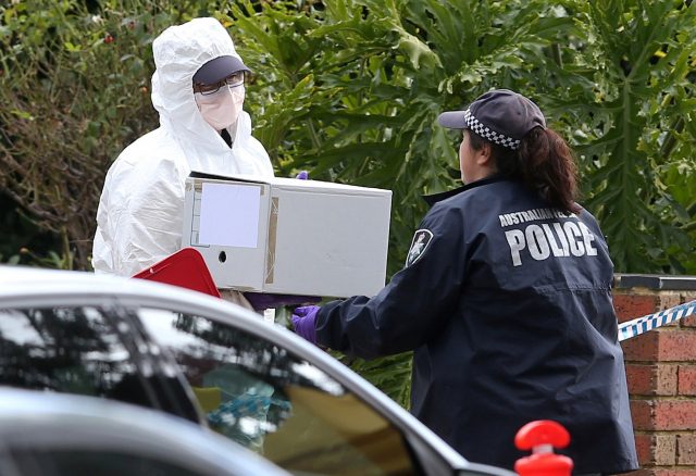 Australian police carry a box as they search what is believed to be the home of gunman Yacqub Khayre, who was shot dead by police on Monday after he shot a man dead and held a woman hostage, in the Melbourne suburb of Roxburgh Park in Australia, June 6, 2017. AAP/David Crosling/via REUTERS ATTENTION EDITORS - THIS PICTURE WAS PROVIDED BY A THIRD PARTY. EDITORIAL USE ONLY. NO RESALES. NO ARCHIVE. AUSTRALIA OUT. NEW ZEALAND OUT.
