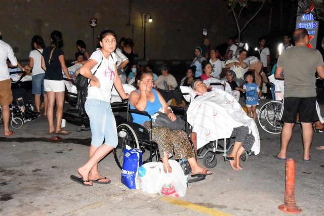 People wait in front of a hospital after an earthquake in the resort town of Bodrum in Mugla province, Turkey, July 21, 2017. Dogan News Agency via REUTERS ATTENTION EDITORS - THIS PICTURE WAS PROVIDED BY A THIRD PARTY. NO RESALES. NO ARCHIVE. TURKEY OUT. NO COMMERCIAL OR EDITORIAL SALES IN TURKEY.