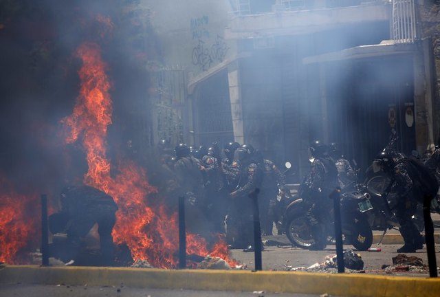 Flames erupt as clashes break out near security forces members while the Constituent Assembly election is being carried out in Caracas, Venezuela, July 30, 2017. REUTERS/Carlos Garcia Rawlins