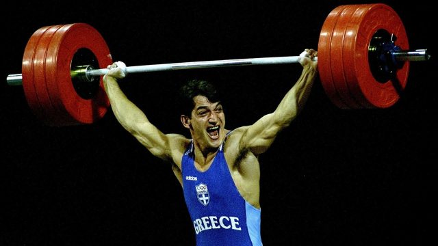 26 Jul 1996: Pyrros Dimas of Greece wins gold in the 83kg weightlifting at the Georgia World Congress Centre at the 1996 Centennial Olympic Games in Atlanta, Georgia.  Mandatory Credit: Rick Stewart  /Allsport