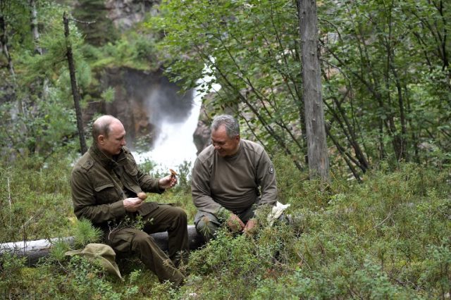 3166087 08/05/2017 Russian President Vladimir Putin and Russian Defense Minister Sergei Shoigu, right, during trekking in the mountains of the Republic of Tyva, during the President's vacation on August 1-3. Aleksey Nikolskyi/Sputnik