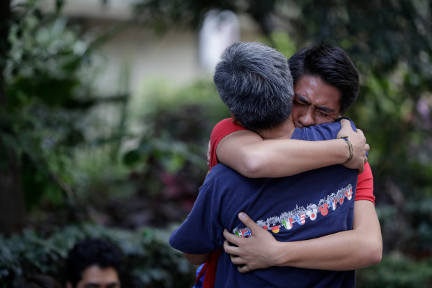 Men hug, crying with joy, as they reunite hours after an earthquake in the Condesa neighborhood of Mexico City, Tuesday, Sept. 19, 2017. A 7.1 earthquake stunned central Mexico, killing more than 100 people as buildings collapsed in plumes of dust. (AP Photo/Rebecca Blackwell)