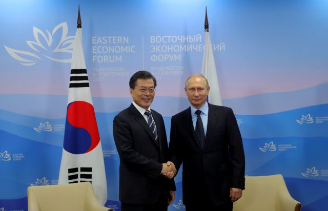 Russian President Vladimir Putin and his South Korean counterpart Moon Jae-in shake hands during a meeting at the Eastern Economic Forum in Vladivostok, Russia September 6, 2017. Sputnik/Mikhail Klimentyev/Kremlin via REUTERS ATTENTION EDITORS - THIS IMAGE WAS PROVIDED BY A THIRD PARTY.