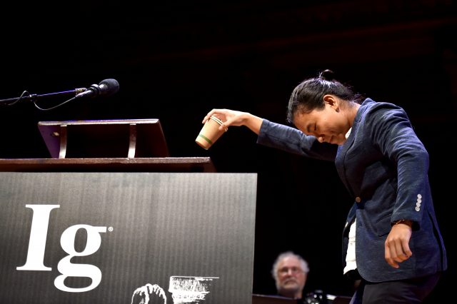 Jiwon Han, a student at the University of Virginia, demonstrates what happens when a person walks backwards while carrying a cup of coffee after being awarded the Ig Noble Fluid Dynamics Prize for "A study on the Coffee Spilling Phenomena in Low Impulse Regime," during the 27th First Annual Ig Nobel Prize Ceremony at Harvard University in Cambridge, Massachusetts, U.S. September 14, 2017.     REUTERS/Gretchen Ertl