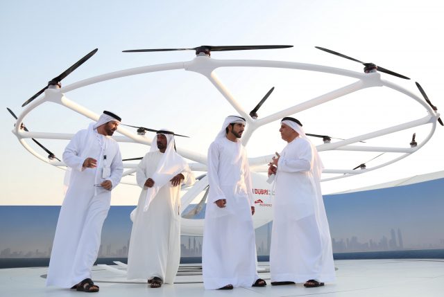 Dubai Crown Prince Sheikh Hamdan bin Mohammed bin Rashid Al Maktoum (2nd R) stands in front of the flying taxi in Dubai, United Arab Emirates September 25, 2017. REUTERS/Satish Kumar