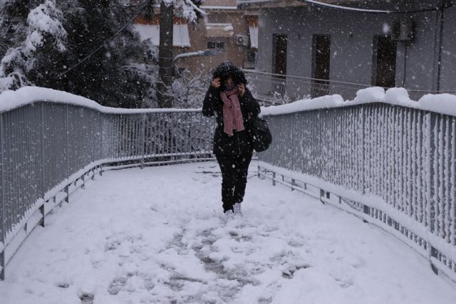 Κοπέλα περπατάει στα χιόνια